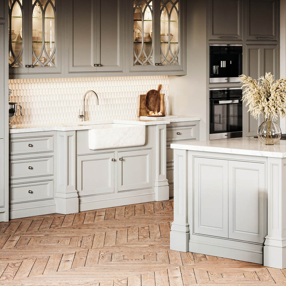 Modern kitchen with gray cabinets, white countertops, and wooden flooring.