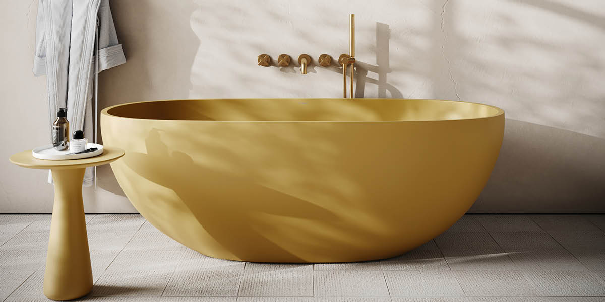 Gold bathtub in a modern bathroom setting.