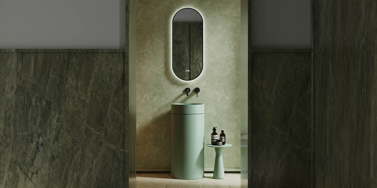 Modern bathroom with a green sink and mirror.