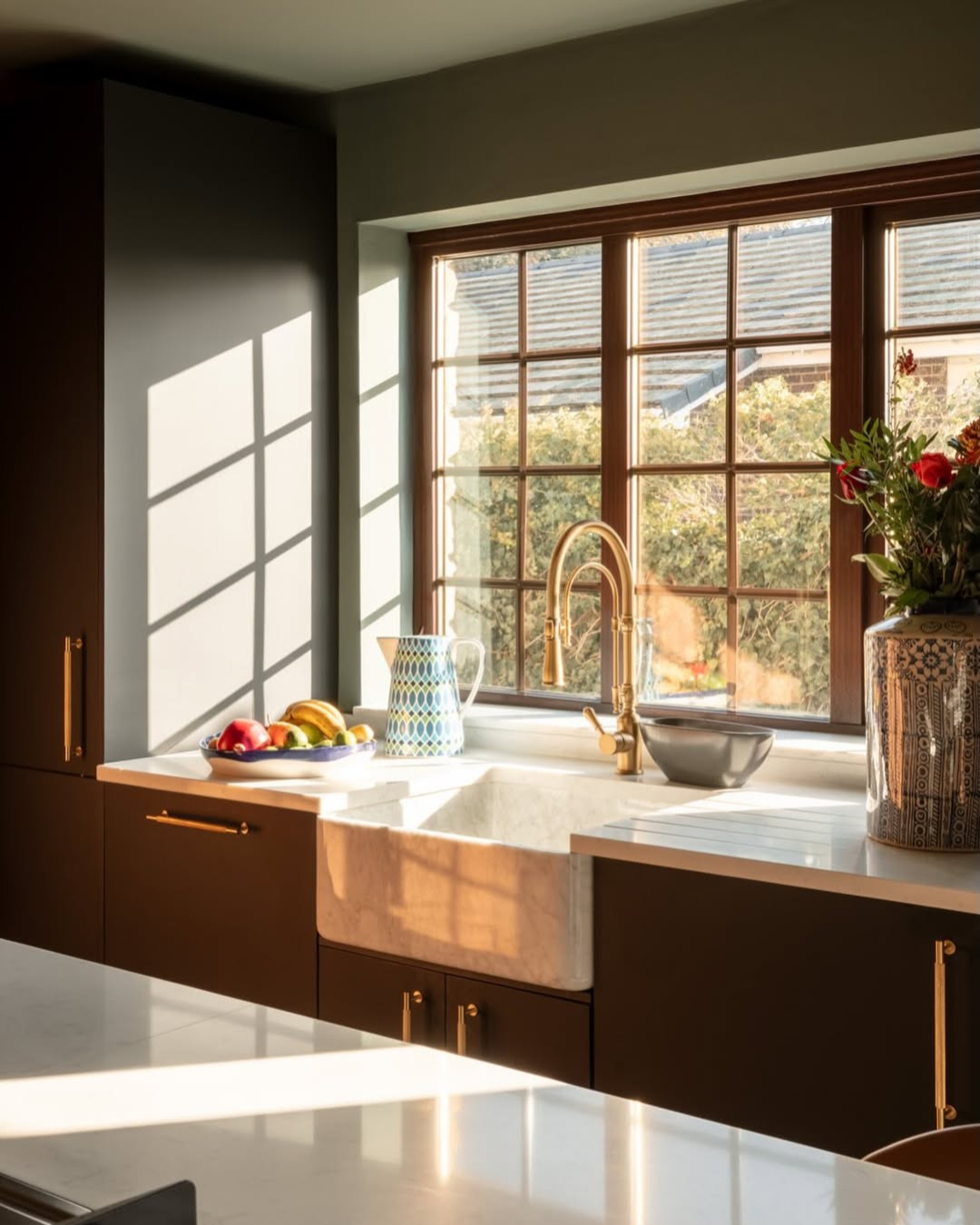Modern kitchen with a large window, sink, and countertop.