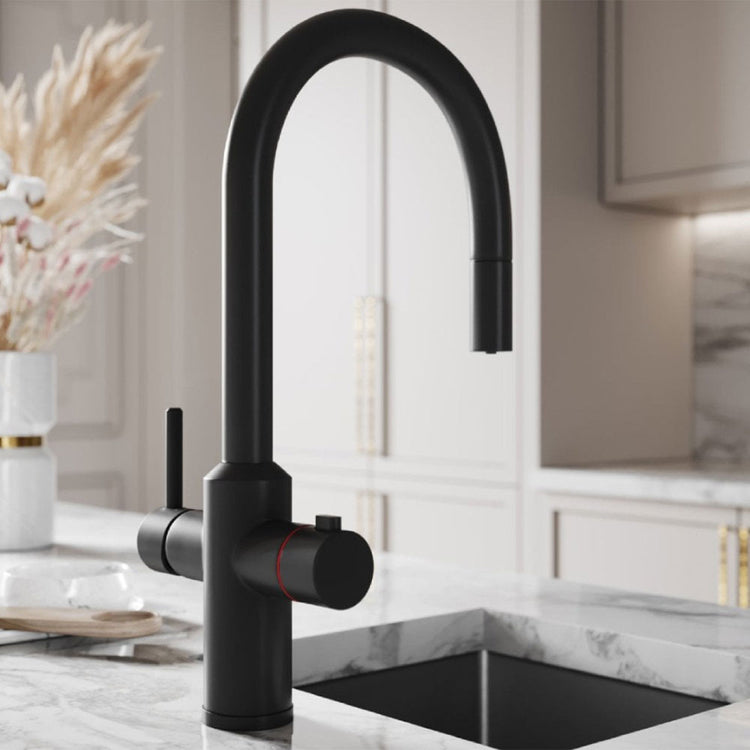 Black kitchen faucet in a modern kitchen setting with marble countertop and decorative elements.