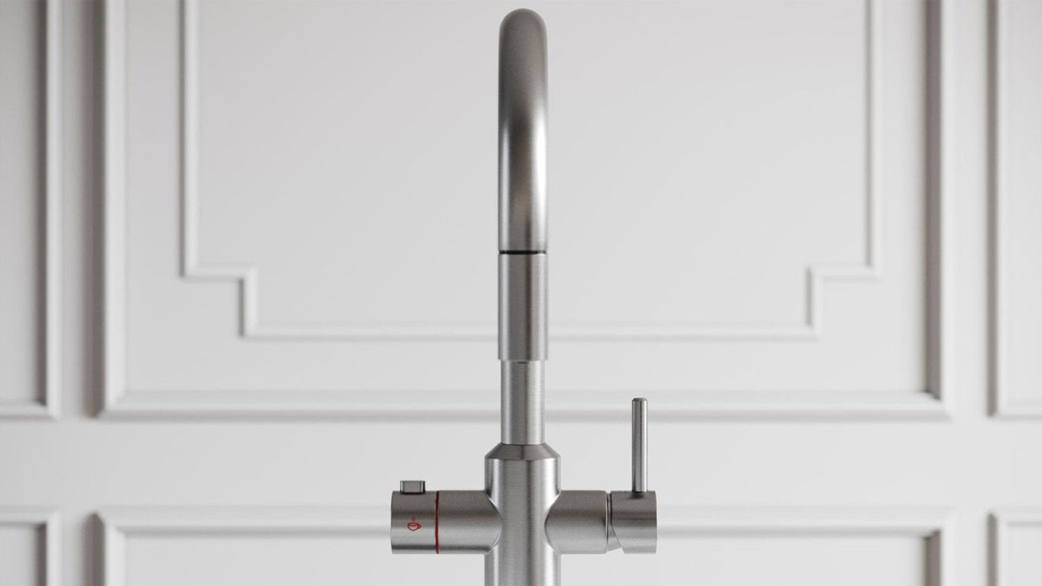 Stainless steel kitchen faucet against a white paneled wall