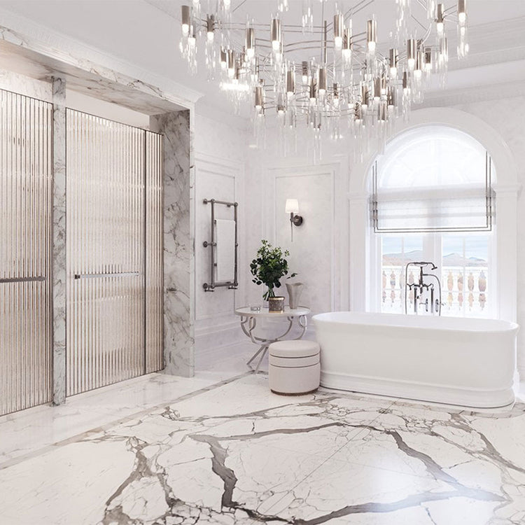 Luxurious bathroom with marble floor, freestanding bathtub, and chandelier.
