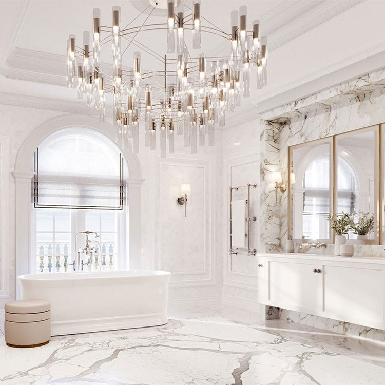 Luxurious bathroom with marble walls, a chandelier, and a bathtub.