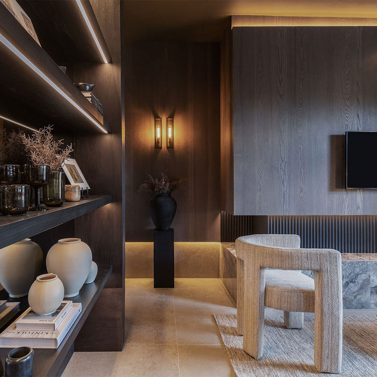 Modern interior design with shelves, decorative items, and a chair.