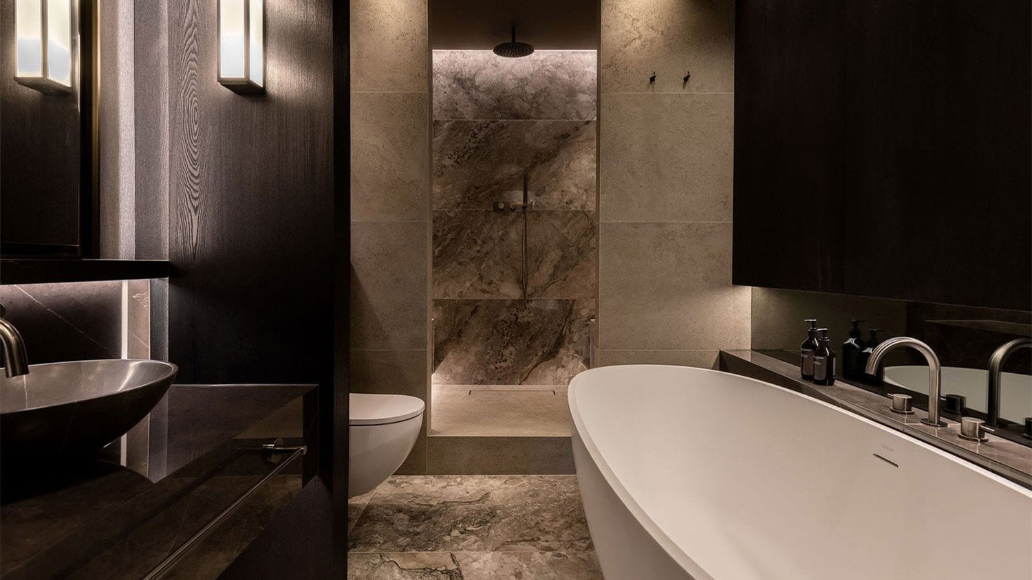 Modern bathroom with a freestanding bathtub, sink, and toilet.