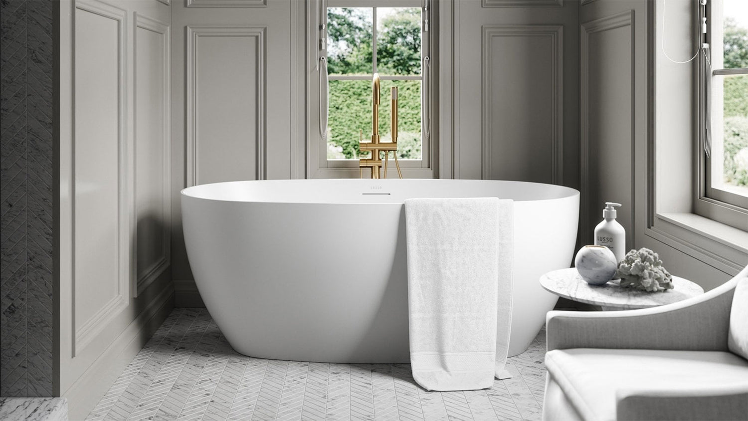 Modern bathroom with a freestanding bathtub, towel, and decorative items.