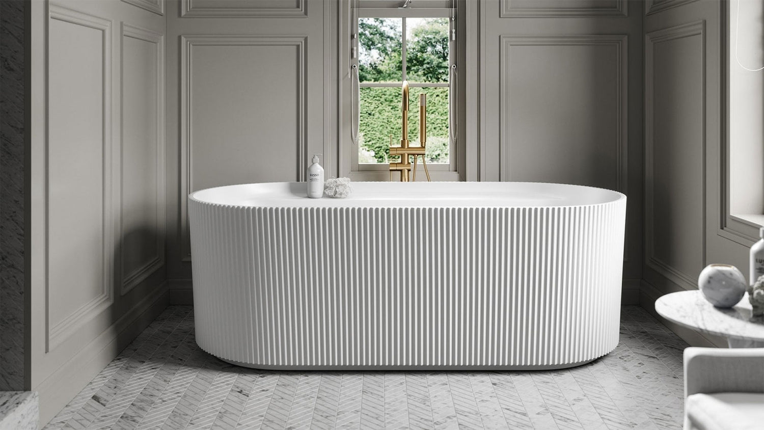 Modern freestanding bathtub in a stylish bathroom with gray walls and a window.
