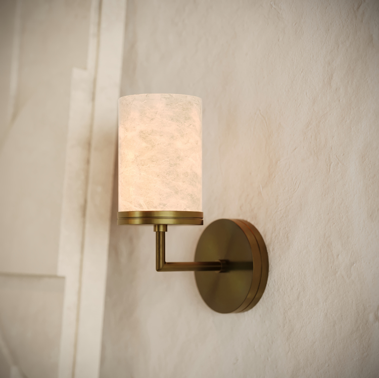 Wall-mounted lamp with a brass fixture and white shade on a textured wall.