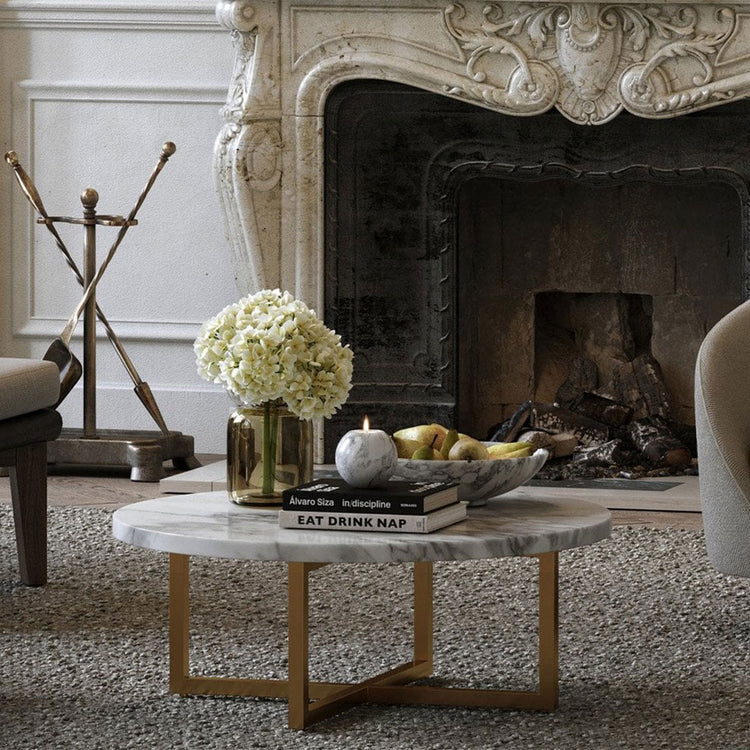Living room with a fireplace, marble coffee table, and decorative items.