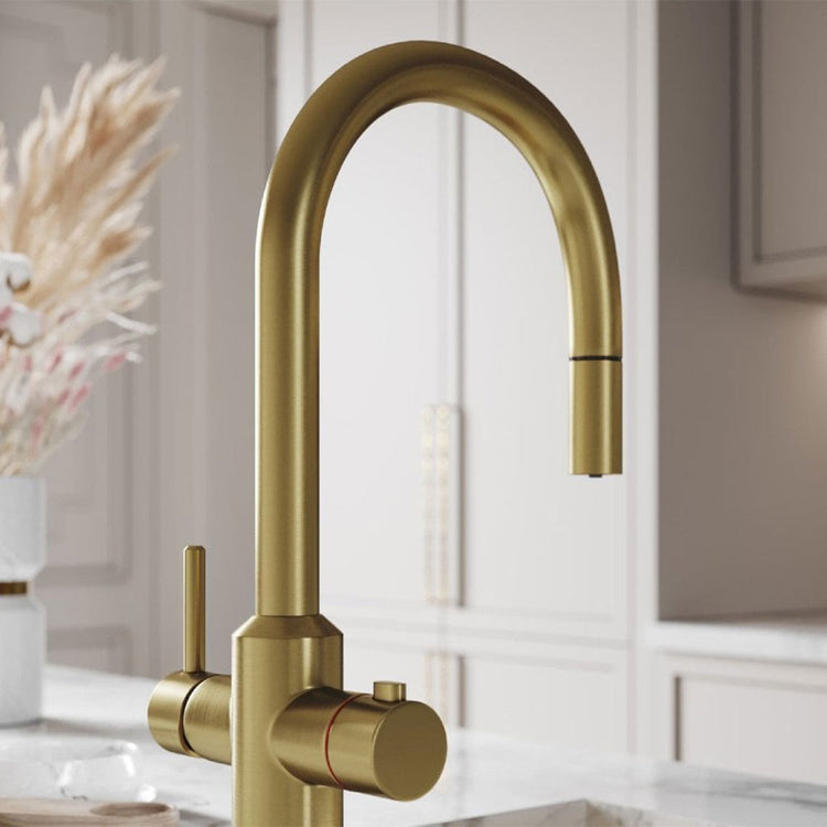 Gold kitchen faucet in a modern kitchen setting