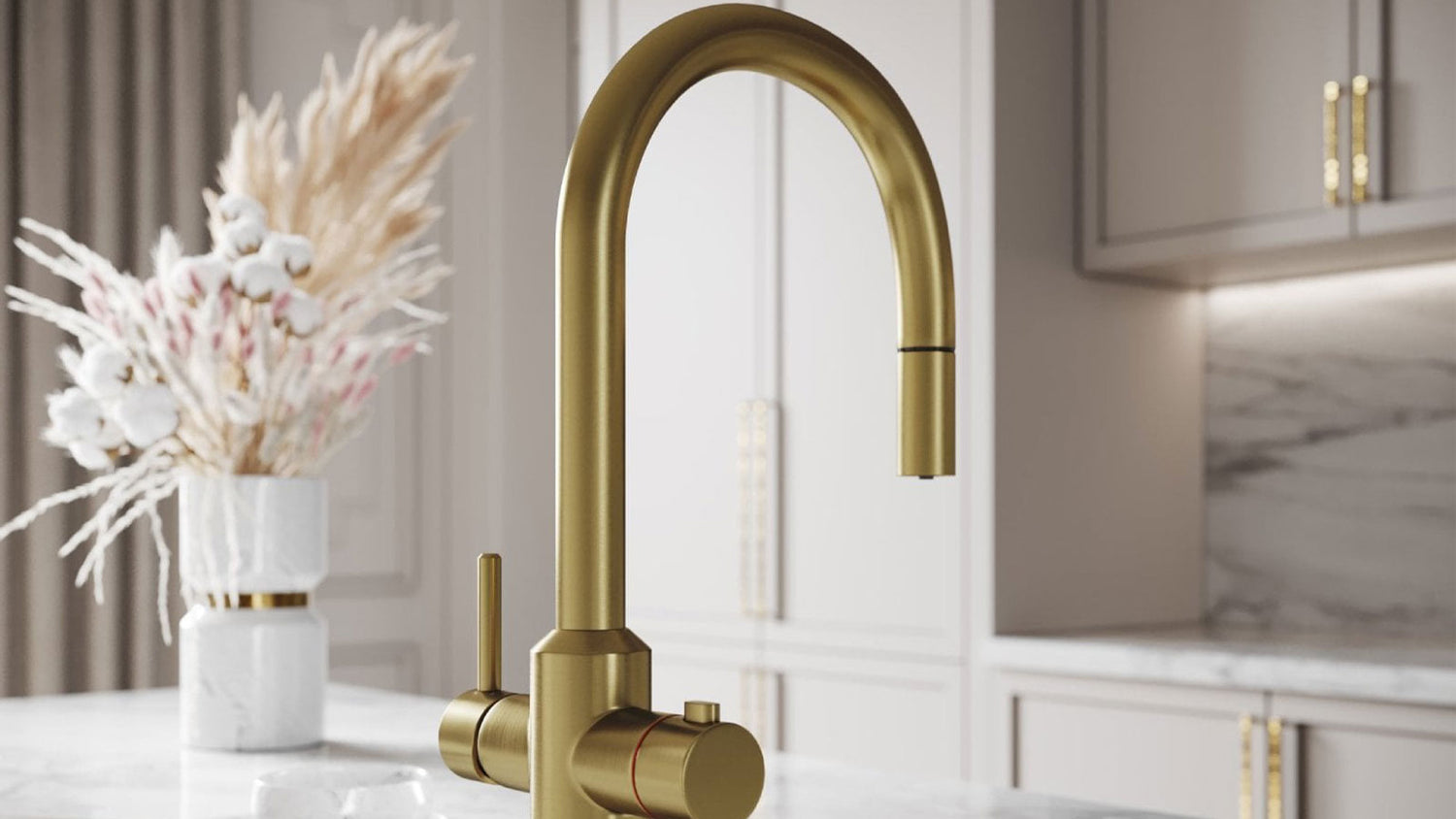 Gold kitchen faucet with decorative elements in a kitchen setting