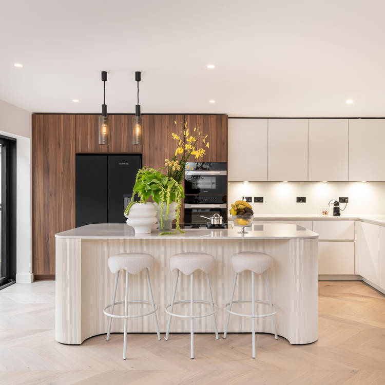 Modern kitchen with a island, bar stools, and wooden cabinets.