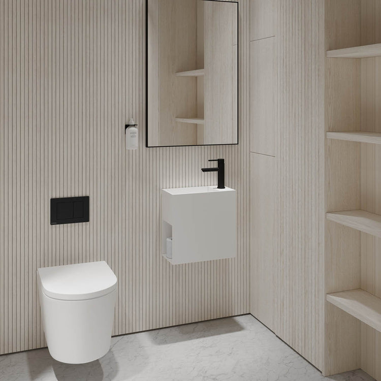 Modern bathroom with a toilet, sink, and mirror against a striped wall.