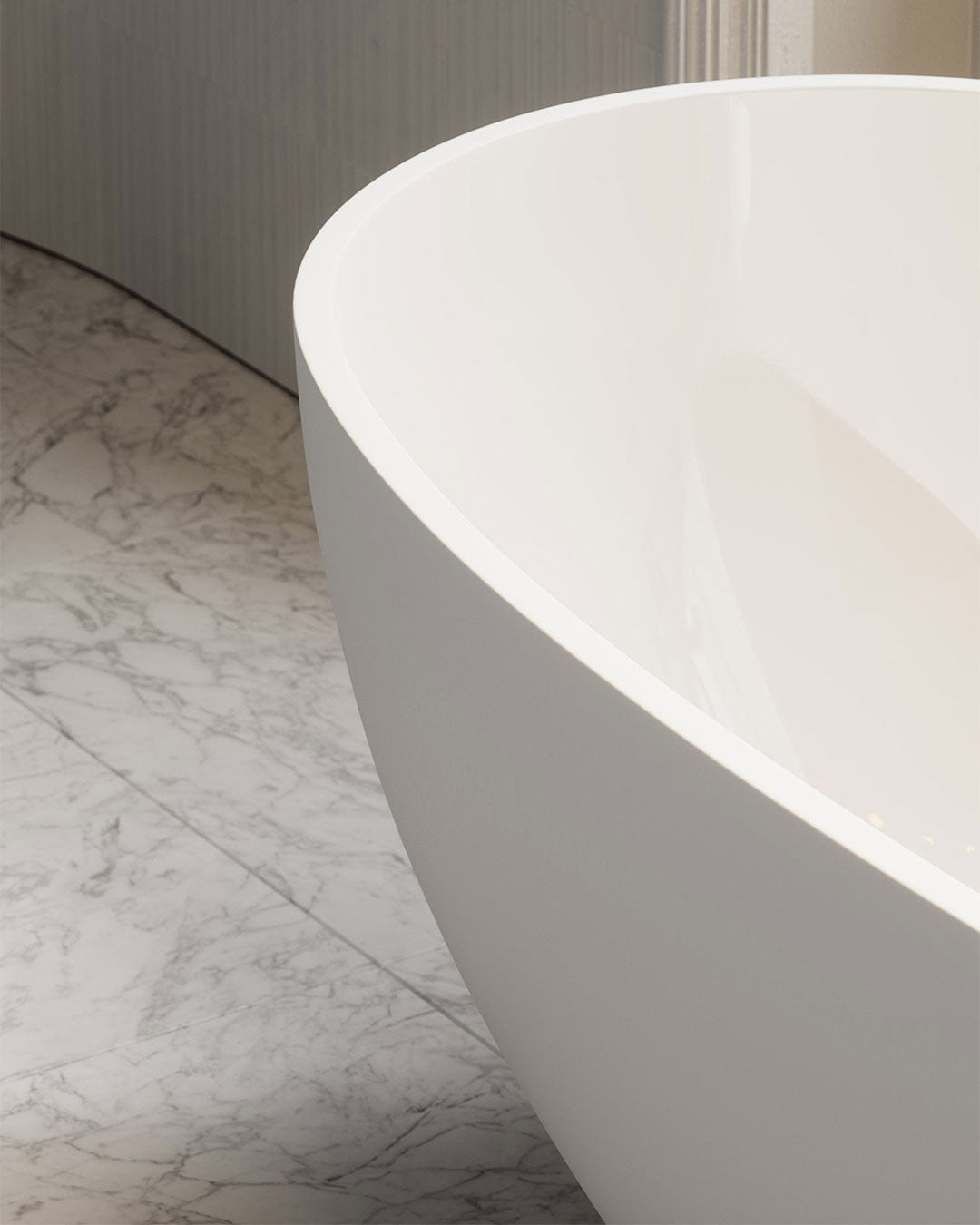 White freestanding bathtub on a marble floor