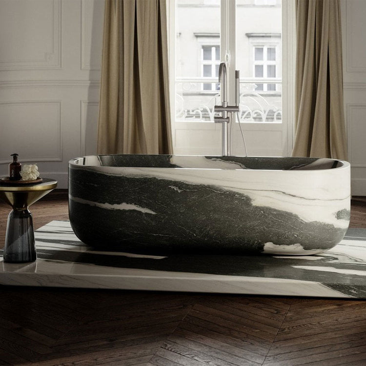 Marble bathtub in a stylish bathroom with large windows and curtains.