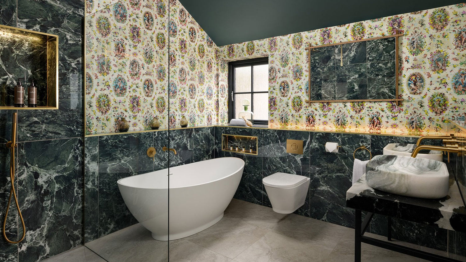 Modern bathroom with green marble walls, floral wallpaper, and white fixtures.