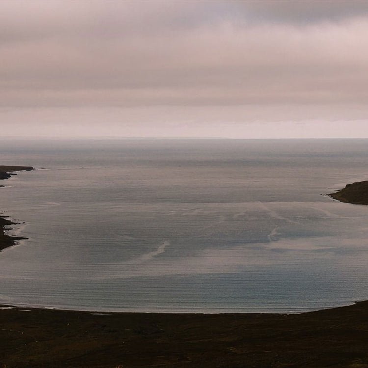 Wide expanse of water with a cloudy sky above