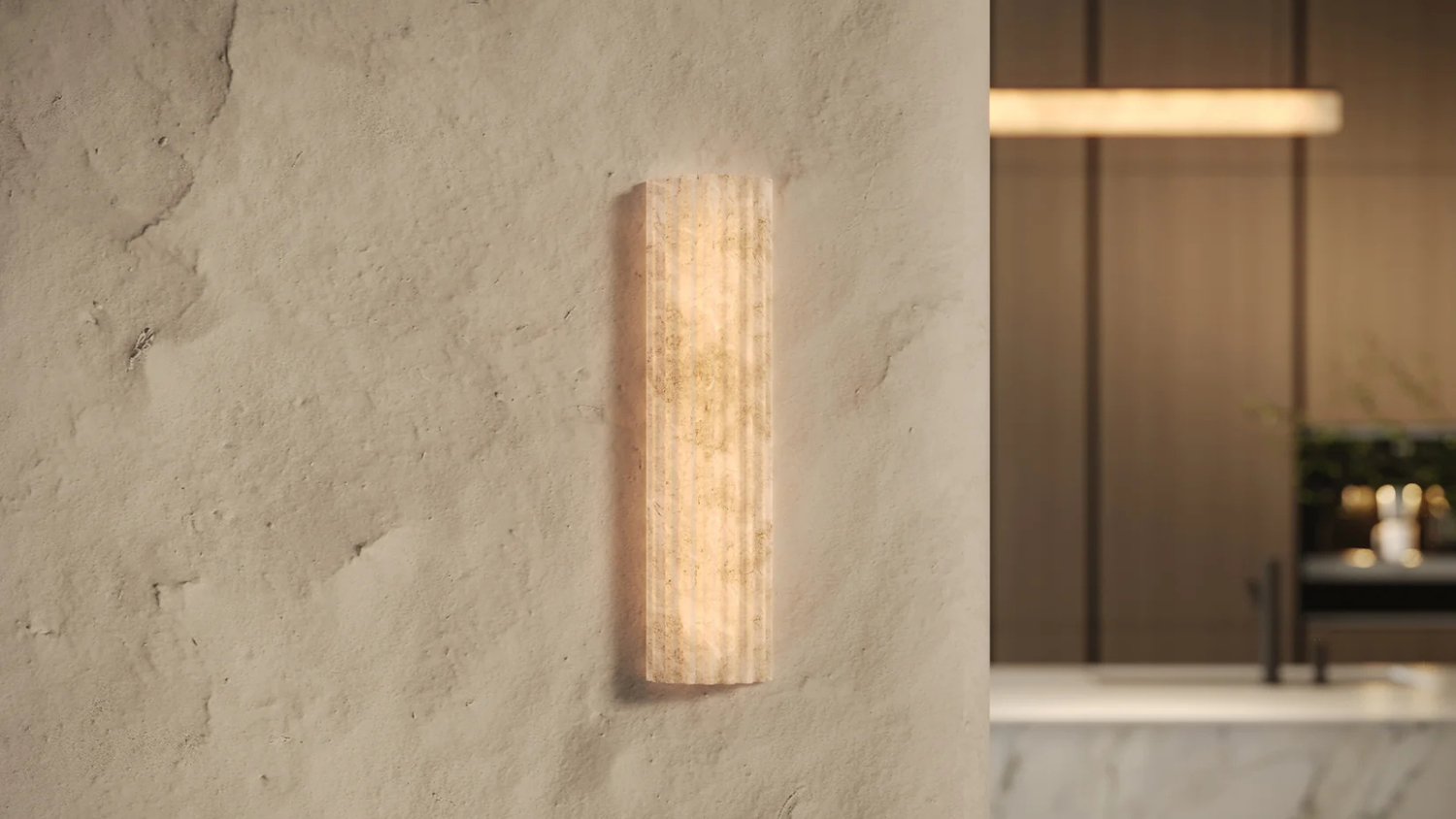 Wall-mounted light fixture on a textured wall with a blurred bathroom background