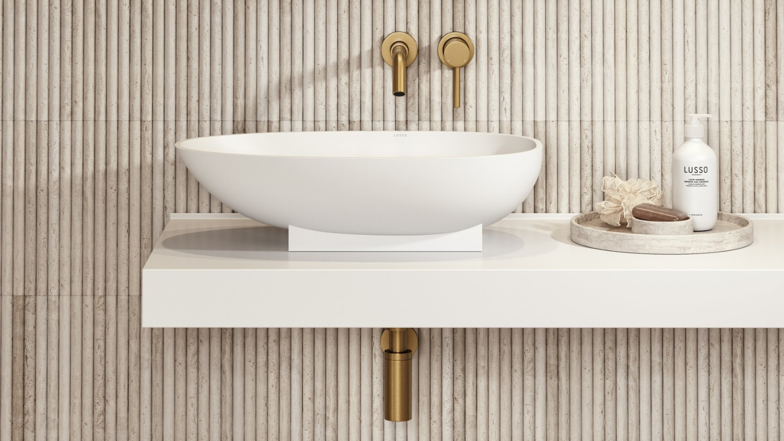 Bathroom sink with gold fixtures against a tiled wall